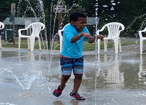 little boy plays in water